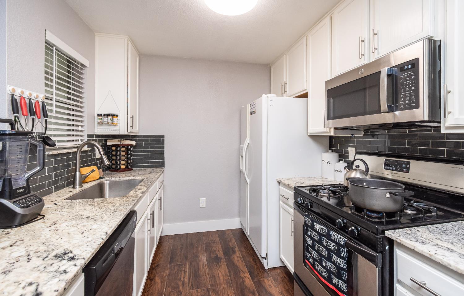 8020 Walerga Road, Unit 1238 Antelope, CA 95843 - Photo 2 of 22 a kitchen with stainless steel appliances granite countertop a sink stove and refrigerator