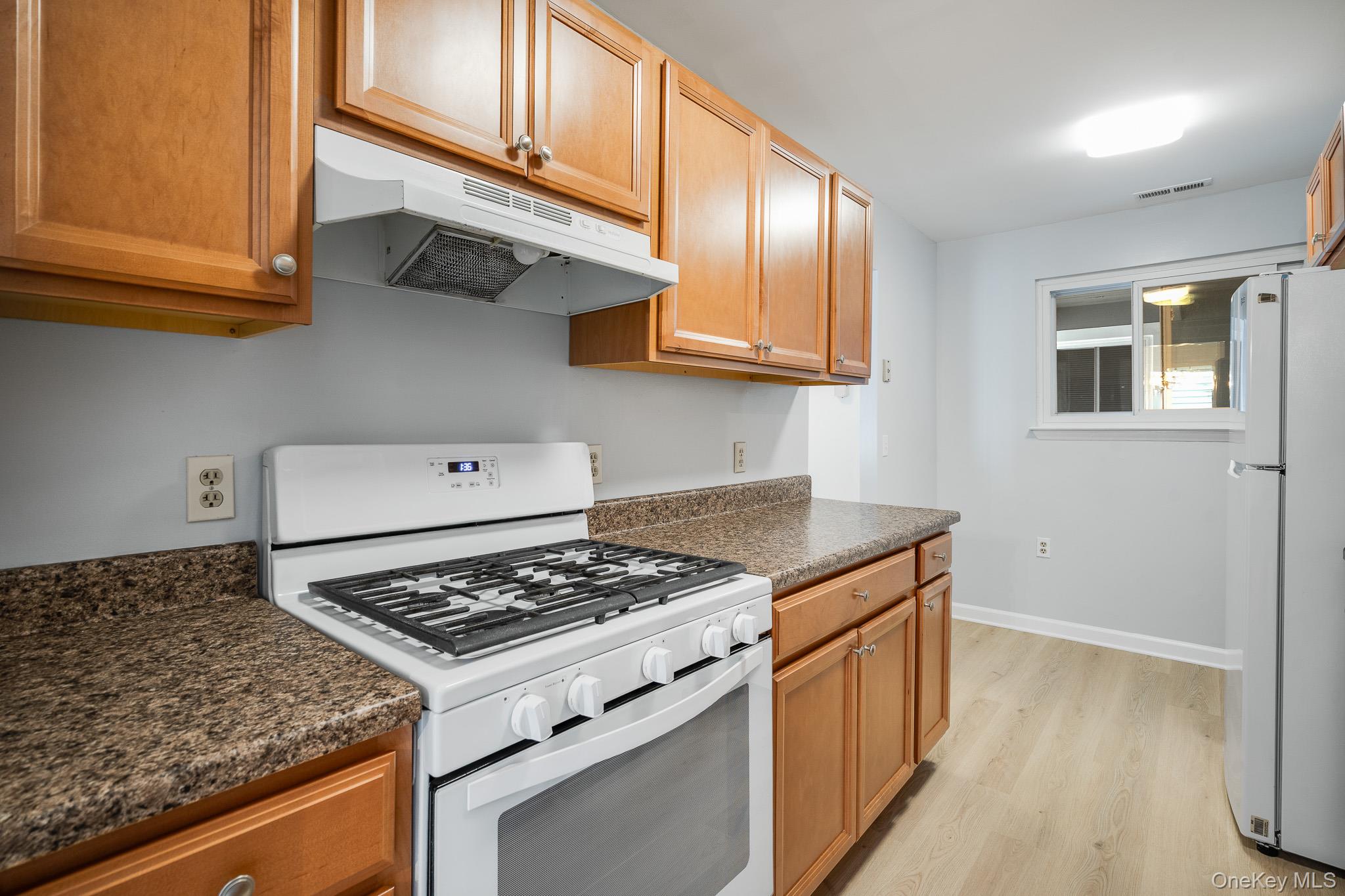 902 Commons Way, Unit F Fishkill, NY 12524 - Photo 11 of 21 a kitchen with stainless steel appliances granite countertop a stove and a sink