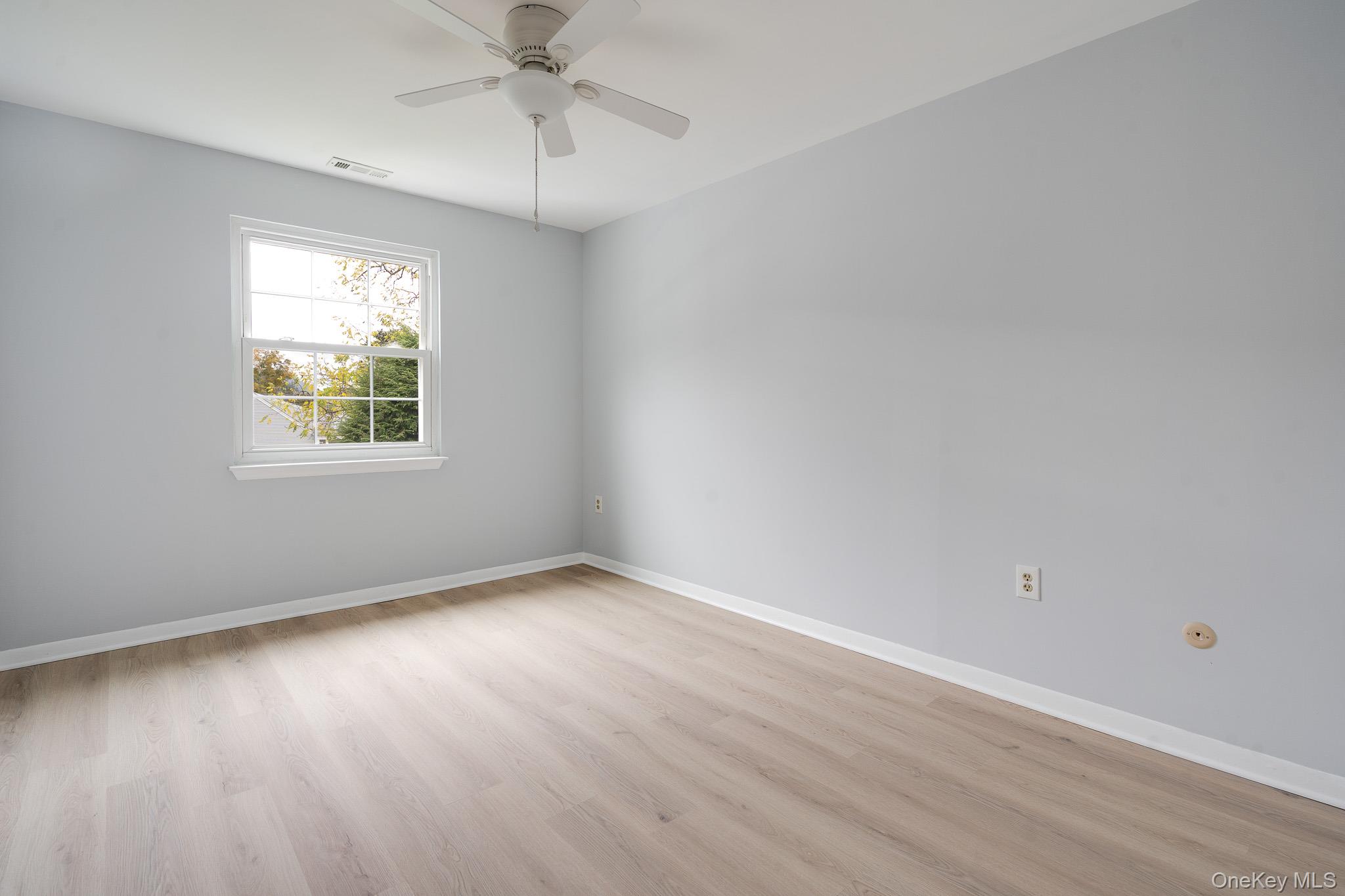 902 Commons Way, Unit F Fishkill, NY 12524 - Photo 12 of 21 wooden floor in an empty room with a window