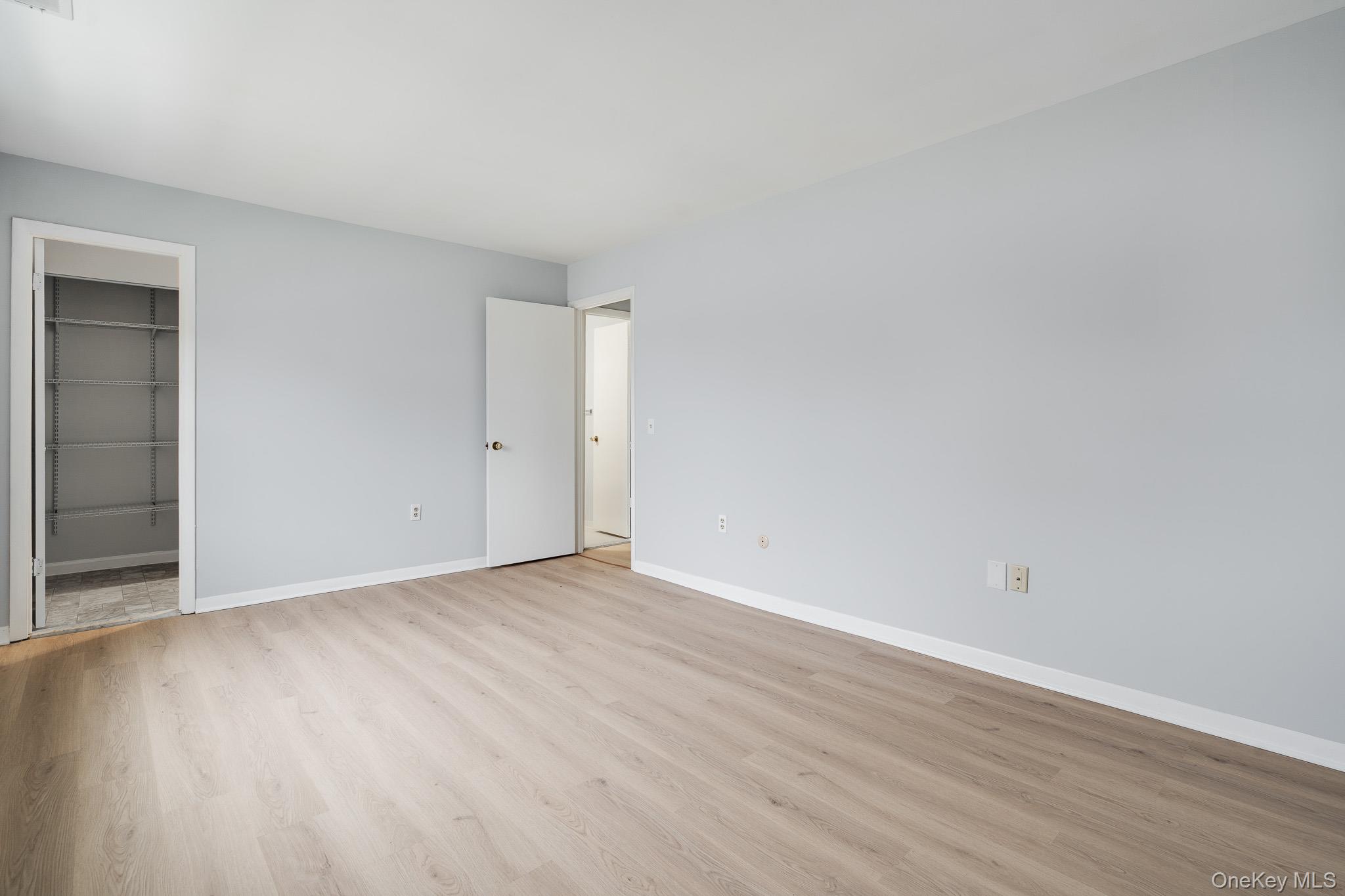 902 Commons Way, Unit F Fishkill, NY 12524 - Photo 15 of 21 a view of an empty room with wooden floor