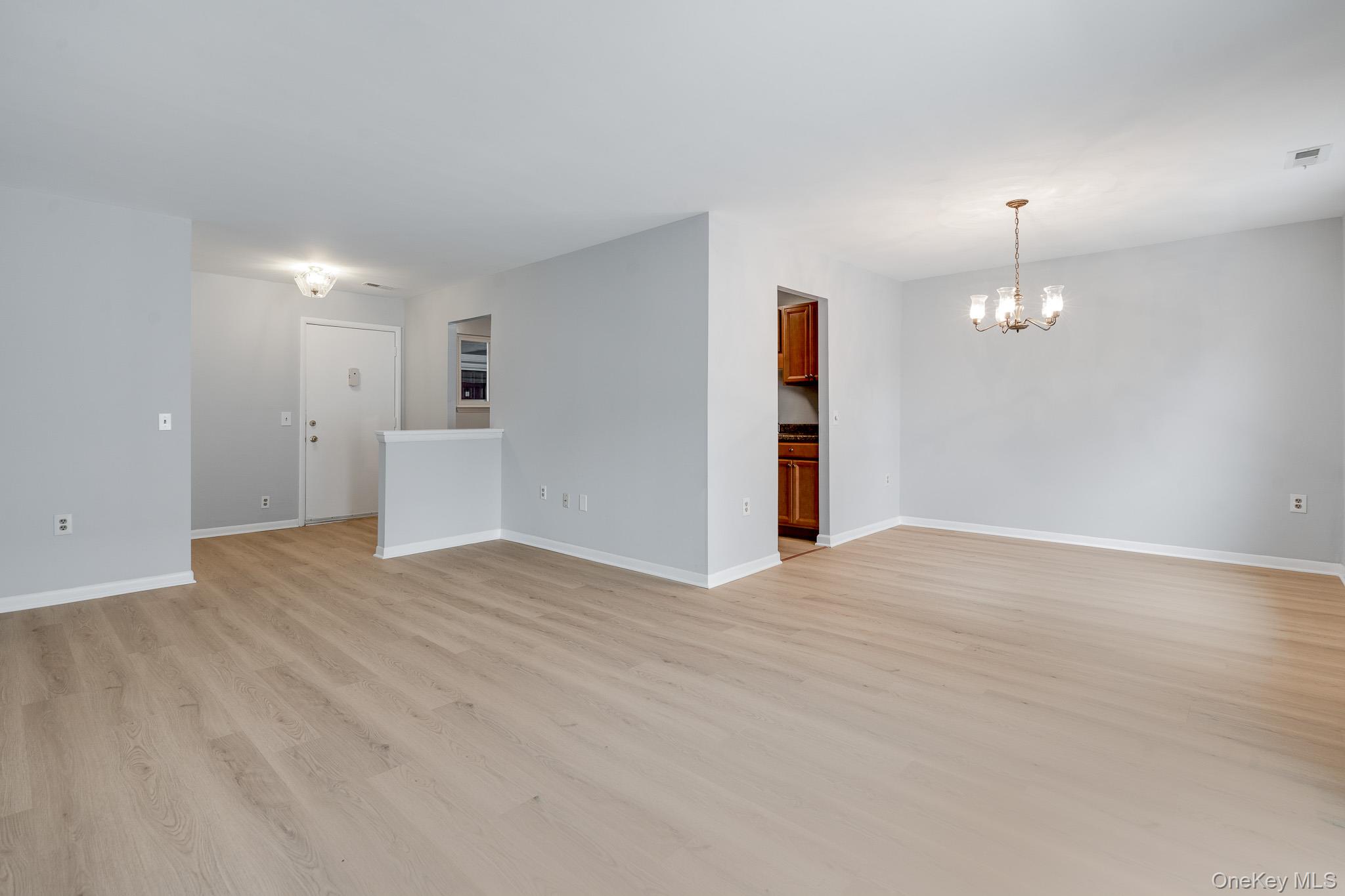 902 Commons Way, Unit F Fishkill, NY 12524 - Photo 5 of 21 a view of empty room with wooden floor and window