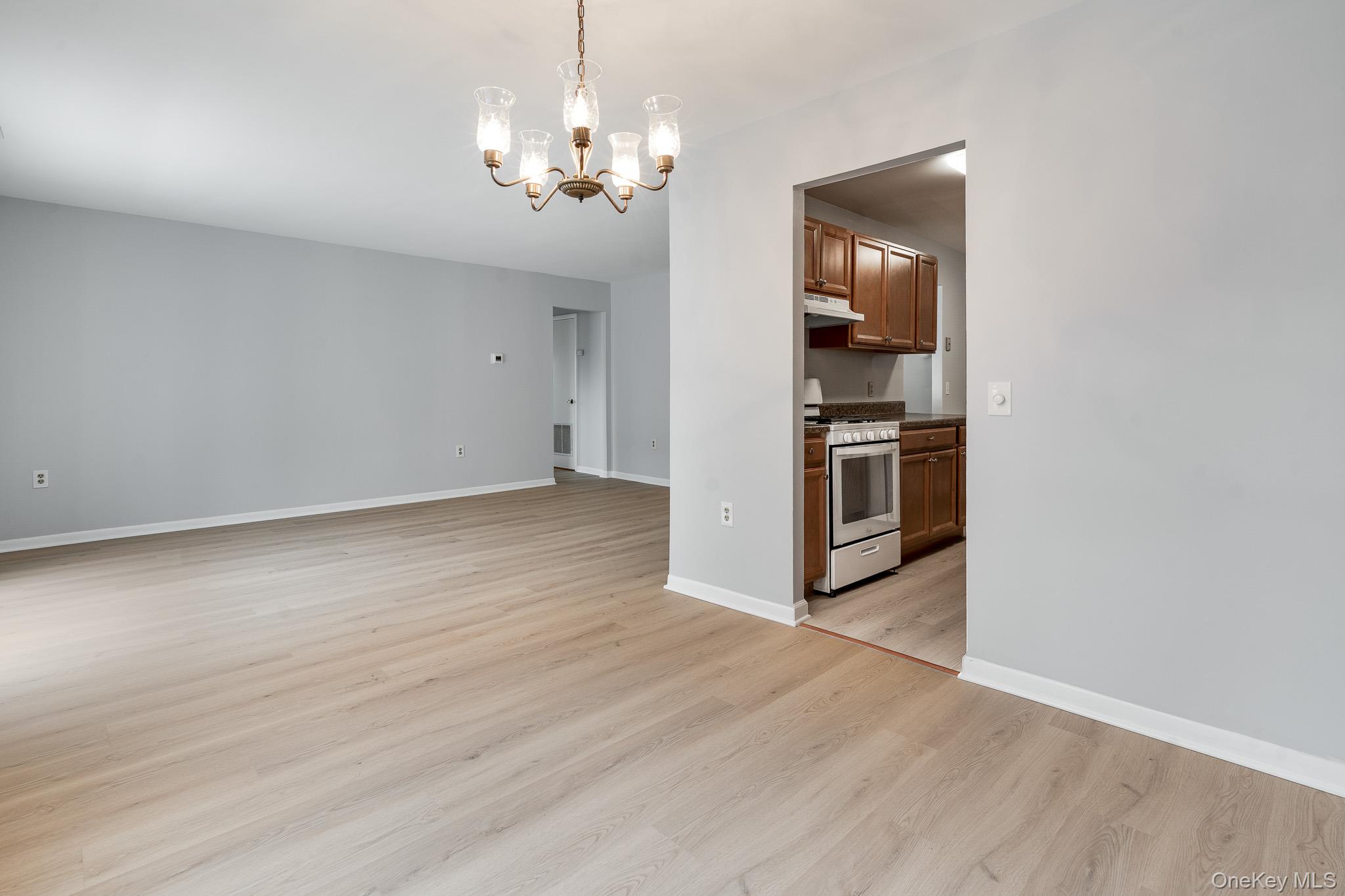 902 Commons Way, Unit F Fishkill, NY 12524 - Photo 8 of 21 a view of a kitchen with a sink and wooden floor