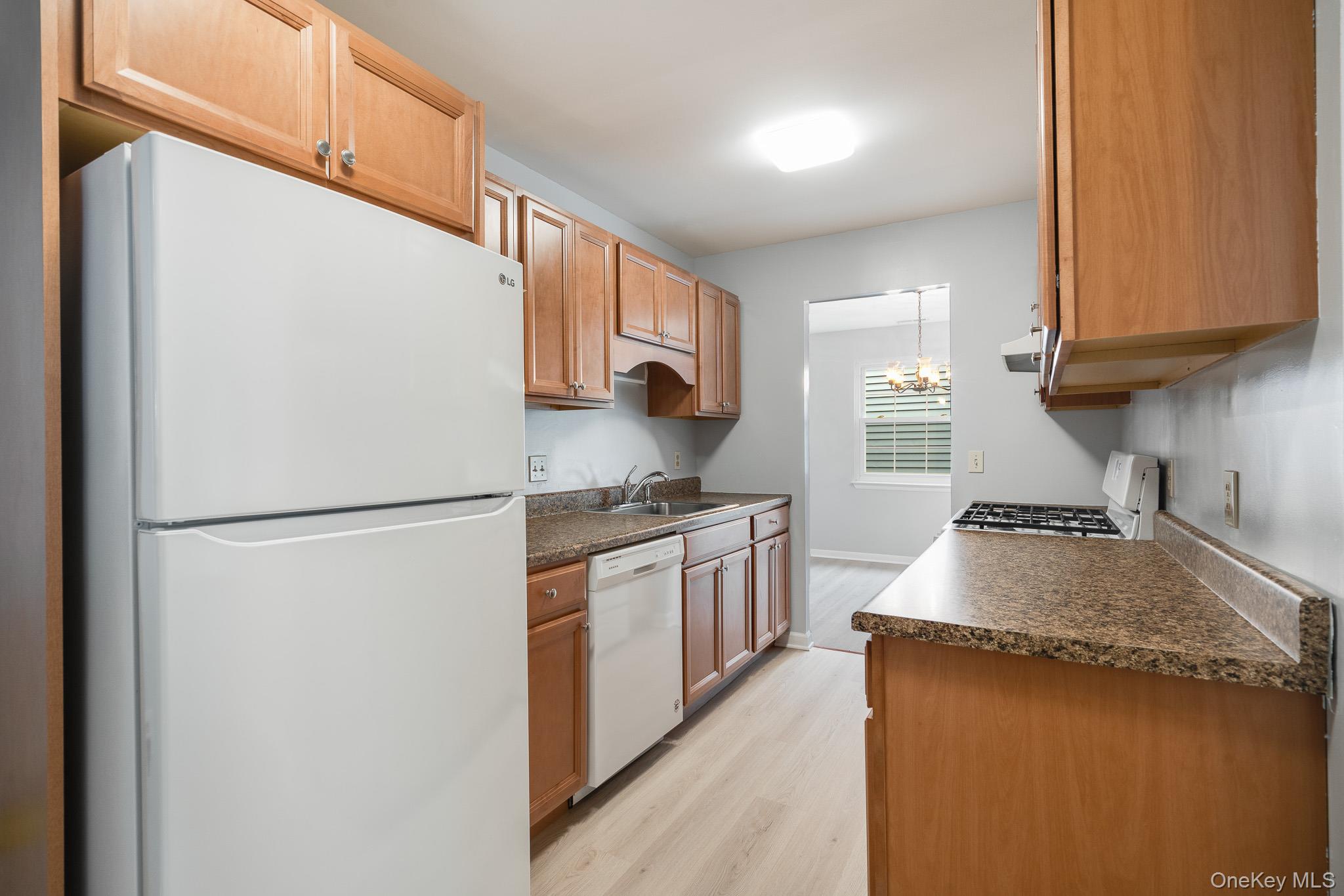 902 Commons Way, Unit F Fishkill, NY 12524 - Photo 9 of 21 a kitchen with a refrigerator sink stove and microwave