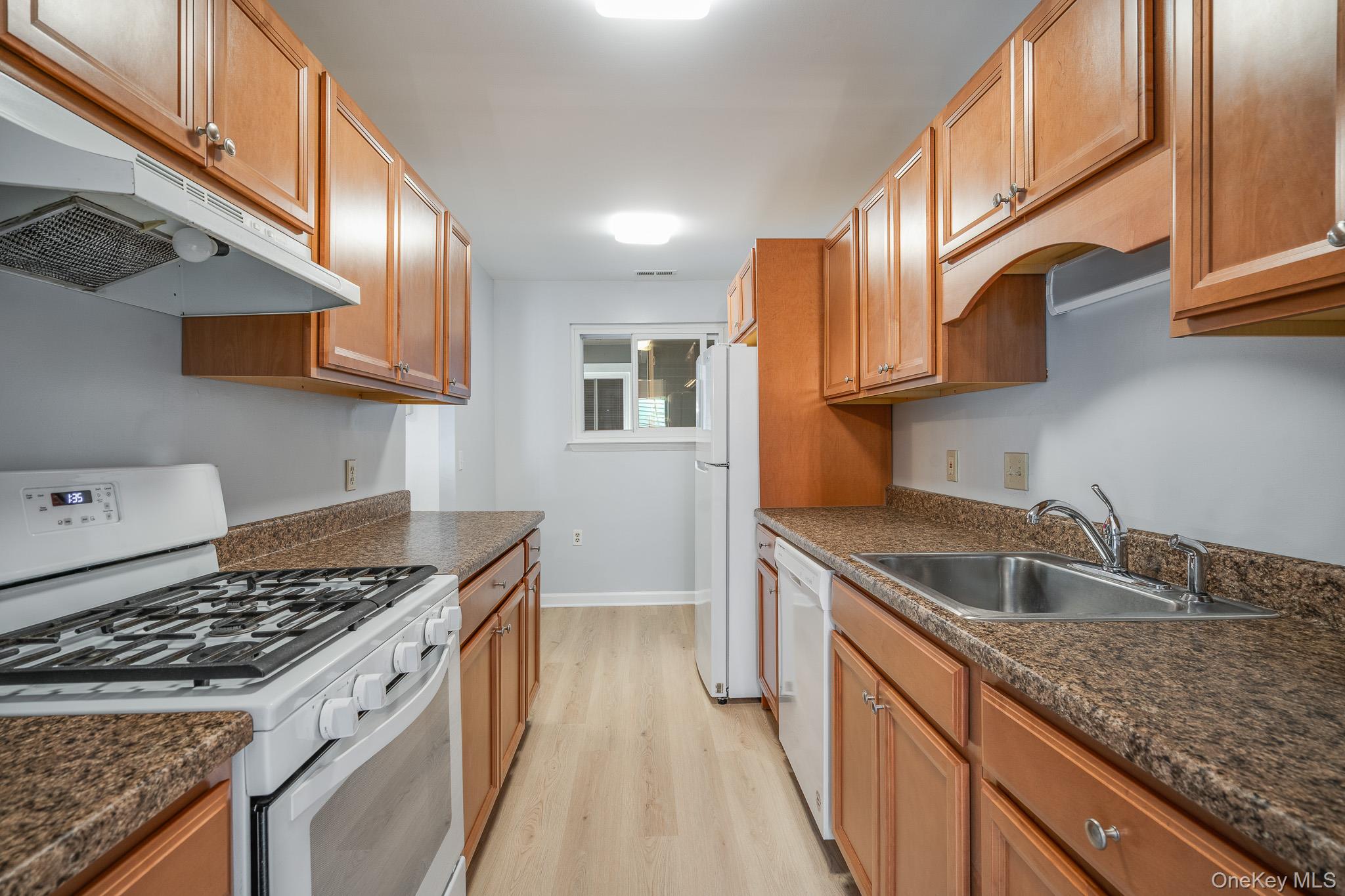 902 Commons Way, Unit F Fishkill, NY 12524 - Photo 10 of 21 a kitchen with stainless steel appliances granite countertop a sink stove and cabinets