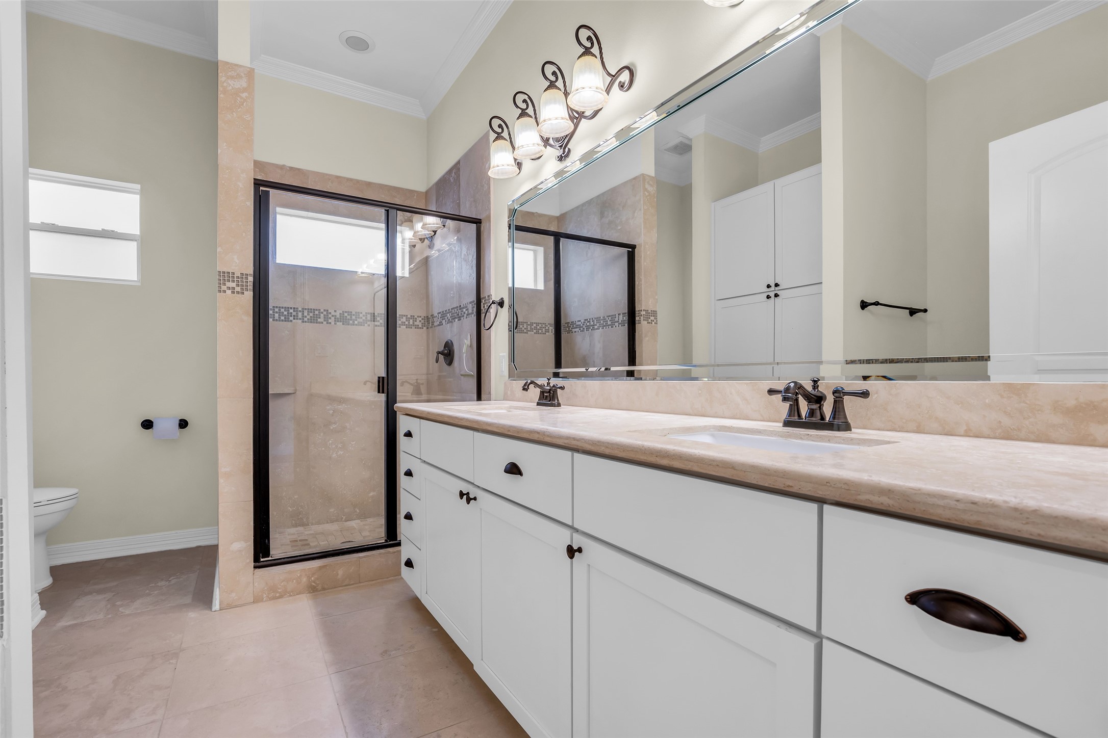 1423 Colorado Street Houston, TX 77007 - Photo 15 of 28 Primary bathroom features an enclosed shower, dual sinks, ample storage space, and modern fixtures, designed for comfort and everyday convenience.