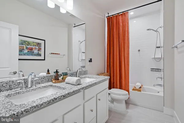 a front view of a house with a lots of flowers