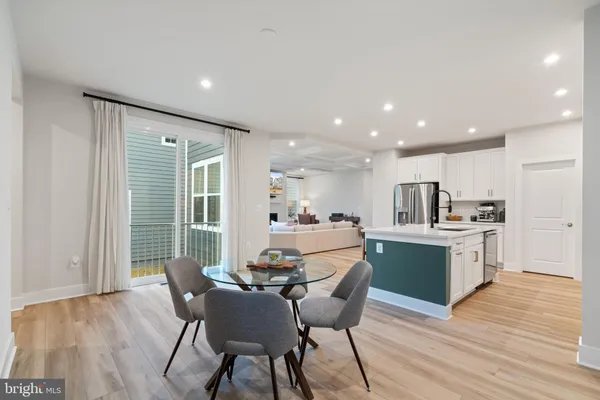 a living room with furniture a fireplace and a large window