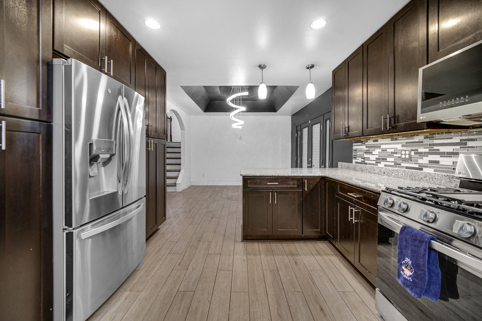 6747 West 450 Road North Michigan City, IN 46360 - Photo 19 of 37 a kitchen with stainless steel appliances granite countertop a stove a refrigerator and a sink