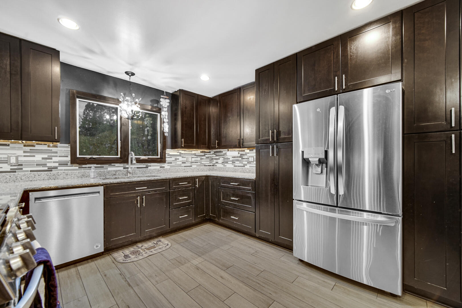 6747 West 450 Road North Michigan City, IN 46360 - Photo 20 of 37 a kitchen with stainless steel appliances granite countertop a refrigerator a sink and wooden cabinets