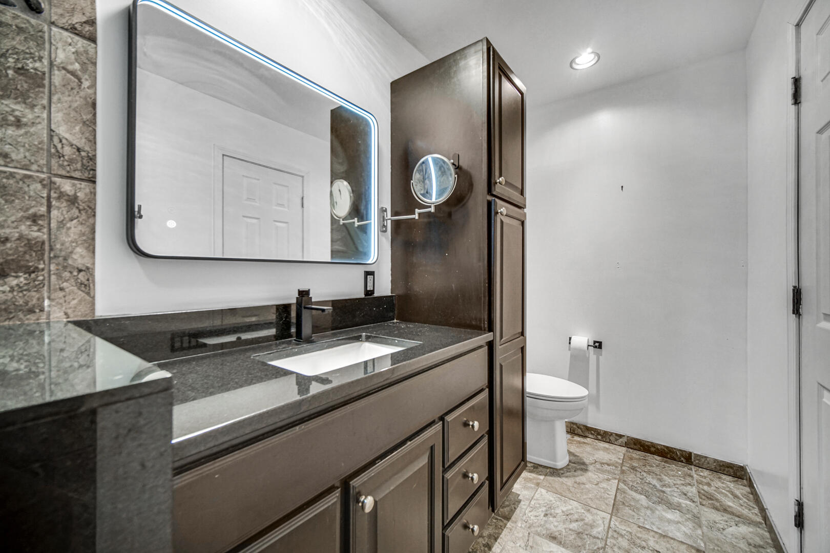 6747 West 450 Road North Michigan City, IN 46360 - Photo 27 of 37 a bathroom with a granite countertop toilet sink and mirror