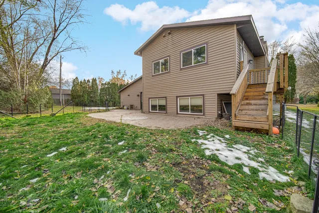 an aerial view of a house with garden space and trees
