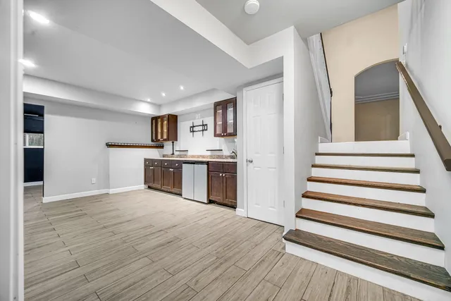 a view of an empty room with a kitchen