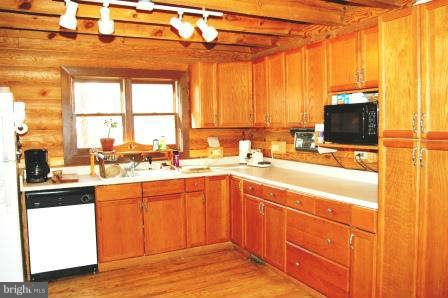 10677 River Road Rixeyville, VA 22737 - Photo 11 of 26 a kitchen with a sink window and cabinets