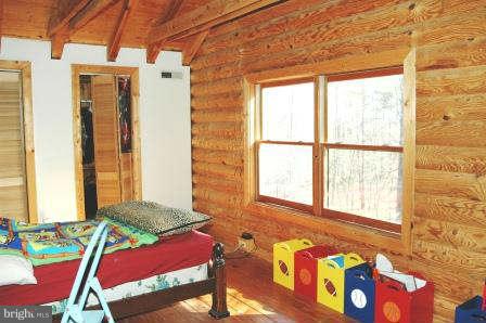 10677 River Road Rixeyville, VA 22737 - Photo 20 of 26 a bedroom with a bed and a window