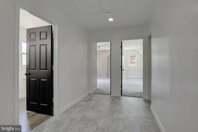 an empty room with closet and a bathroom