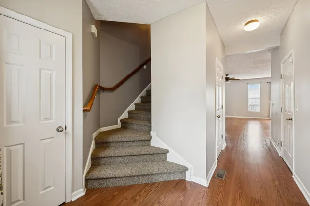 a view of a hallway with wooden floor and entryway