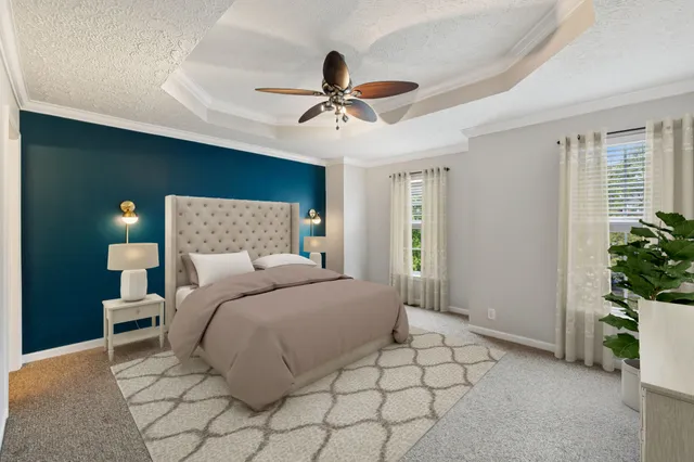 a bedroom with a bed and a potted plant