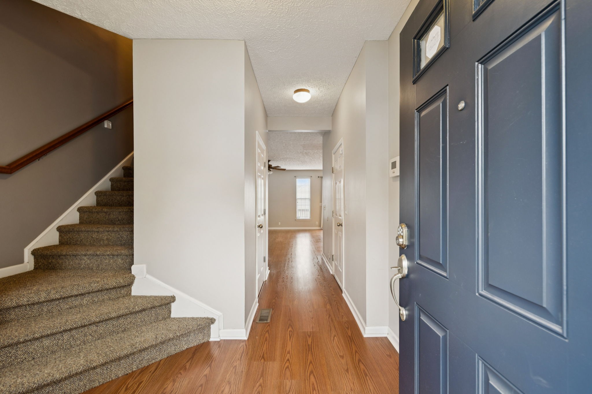 1345 Bell Road, Unit 412 Antioch, TN 37013 - Photo 3 of 34 a view of a hallway with wooden floor and staircase