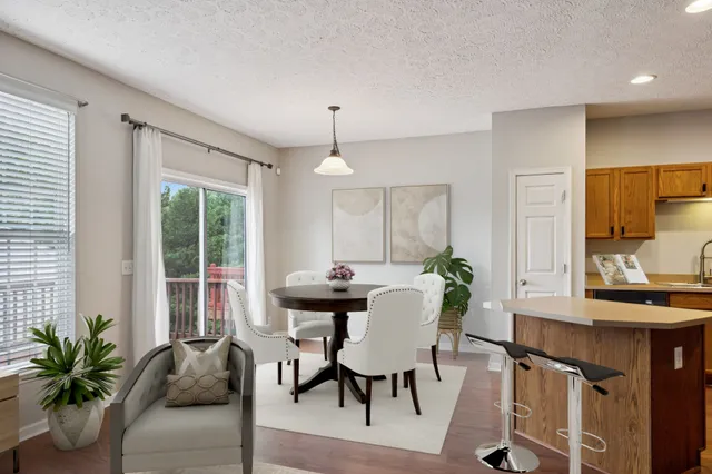 a view of a dining room with furniture and window