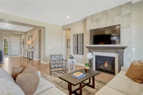 a living room with furniture a flat screen tv and a fireplace