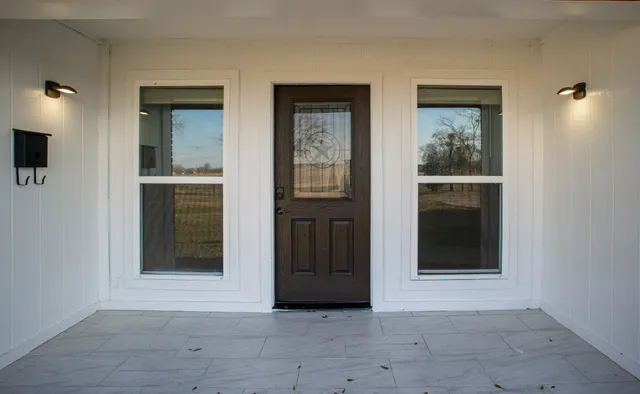 an empty room with windows and closet