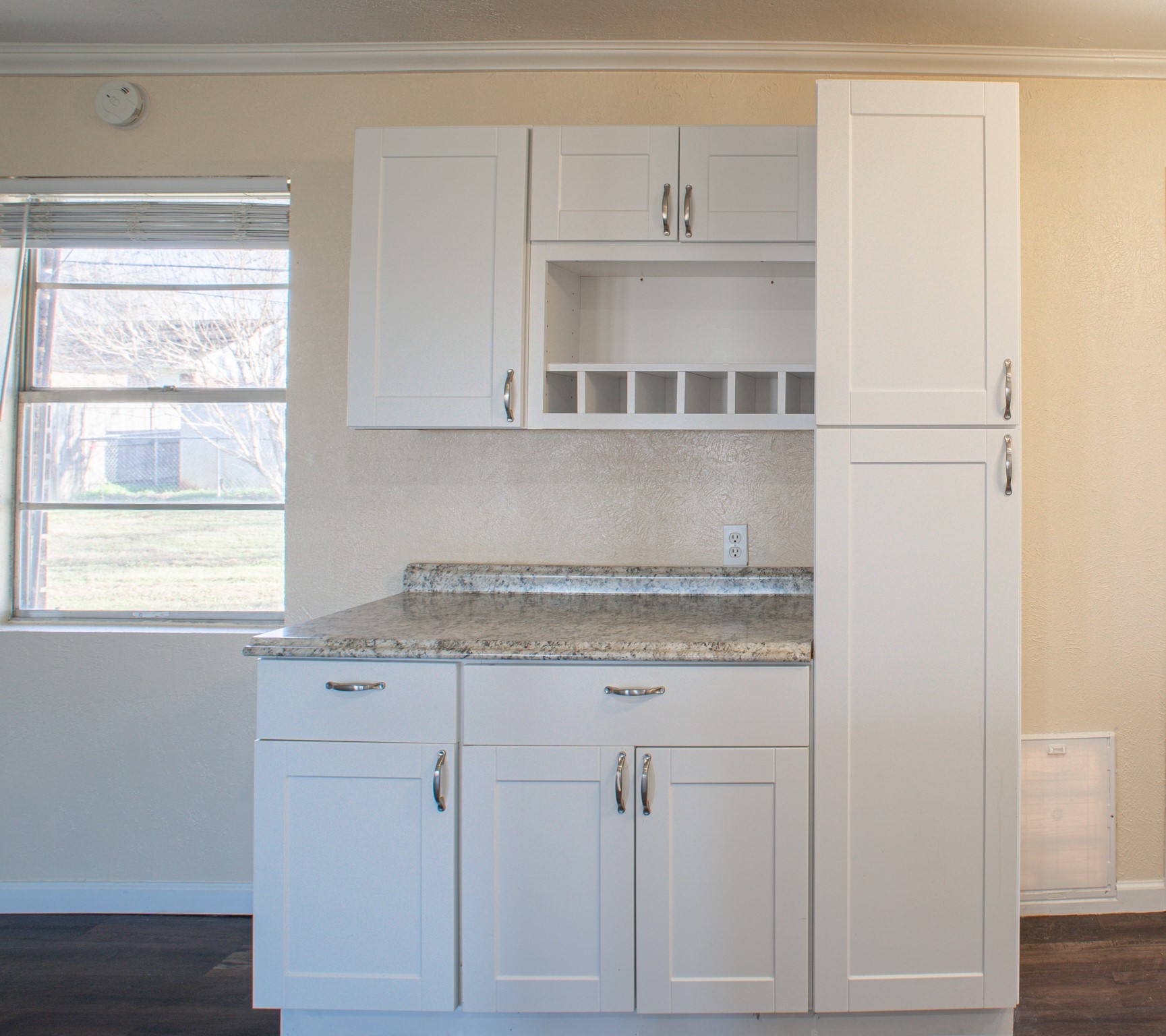 214 North Calhoun Street Groesbeck, TX 76642 - Photo 12 of 20 a kitchen with granite countertop white cabinets and white appliances