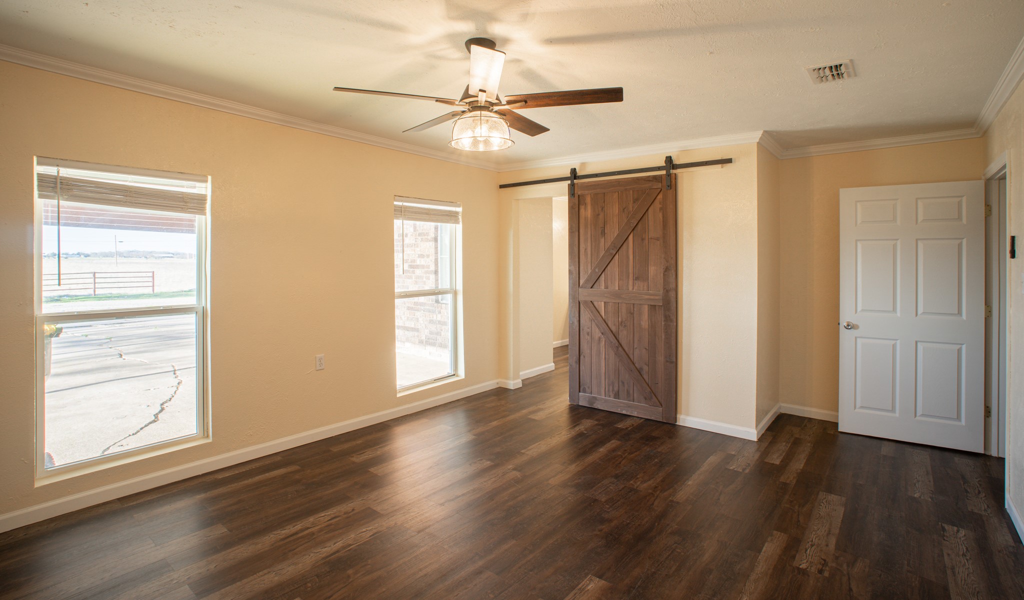 214 North Calhoun Street Groesbeck, TX 76642 - Photo 13 of 20 a view of an empty room with wooden floor and a window