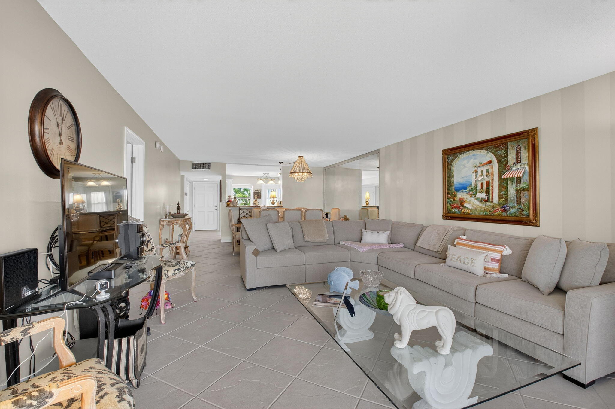 2871 North Ocean Boulevard, Unit R254 Boca Raton, FL 33431 - Photo 17 of 67 a living room with furniture a rug and a flat screen tv