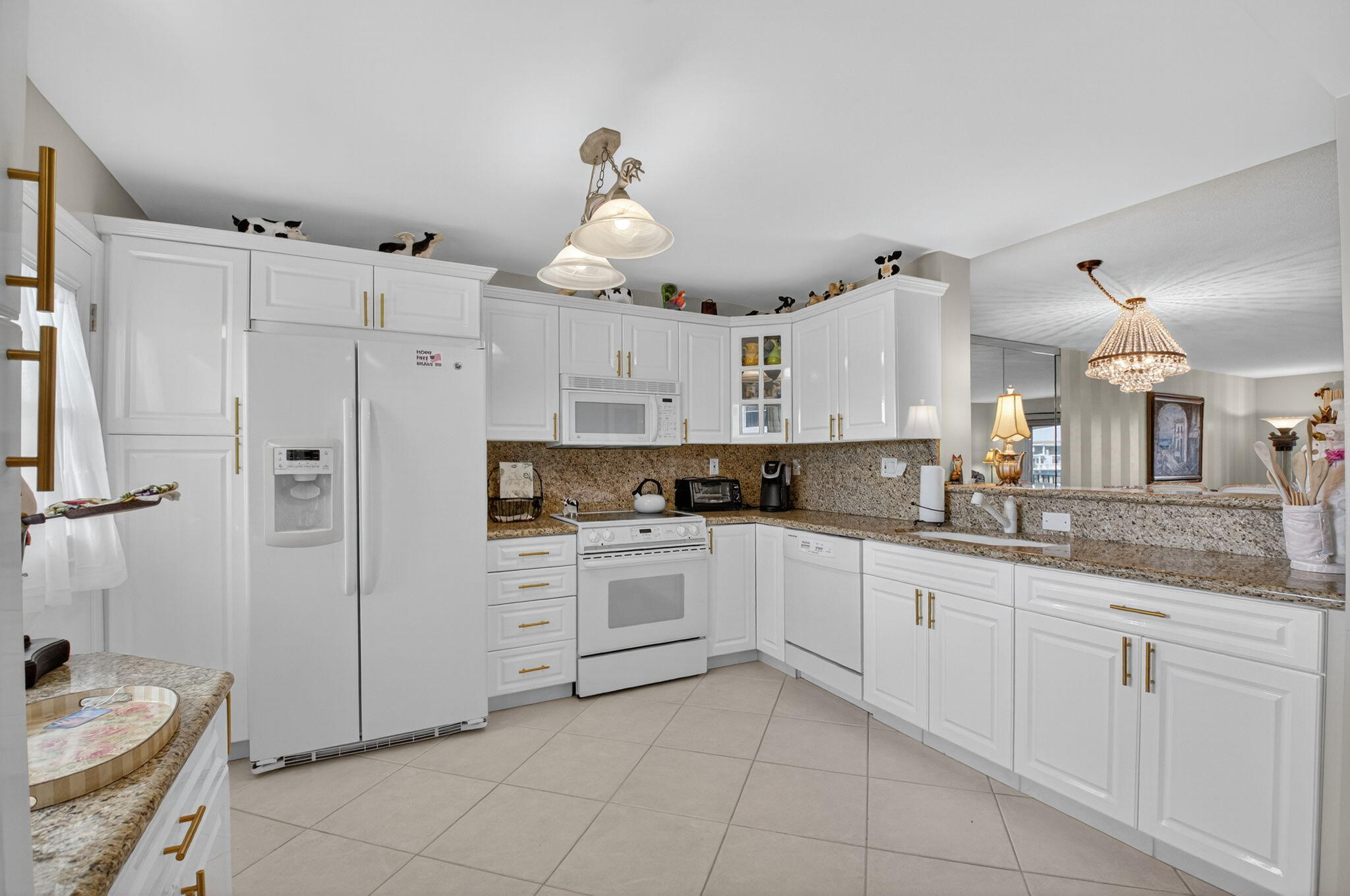 2871 North Ocean Boulevard, Unit R254 Boca Raton, FL 33431 - Photo 21 of 67 a kitchen with white cabinets and white appliances