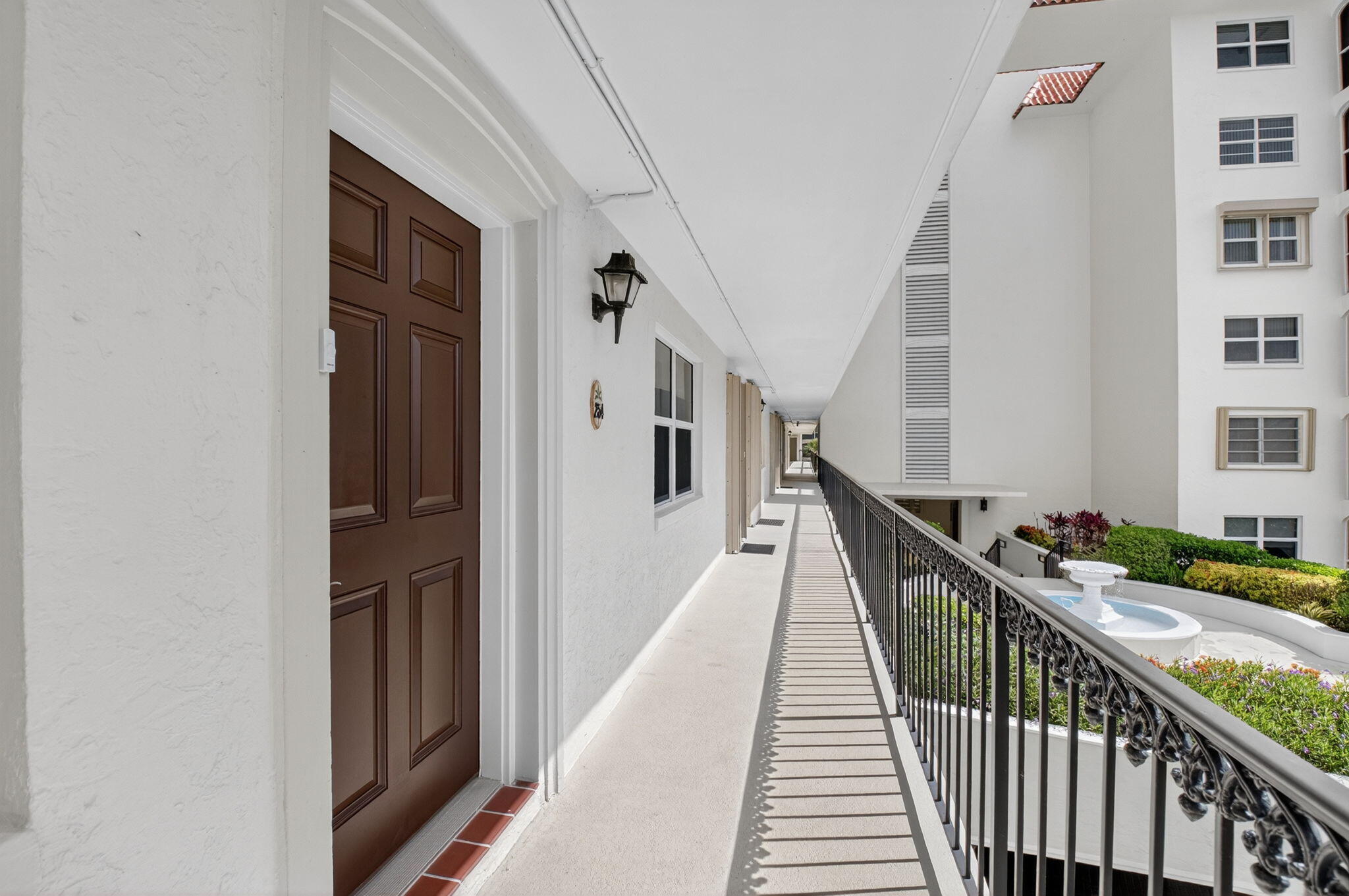 2871 North Ocean Boulevard, Unit R254 Boca Raton, FL 33431 - Photo 10 of 67 a view of a hallway with wooden floor and staircase
