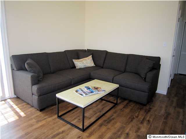 3305 Seaview Road Lavallette, NJ 08735 - Photo 4 of 13 a living room with furniture a rug and a wooden floor