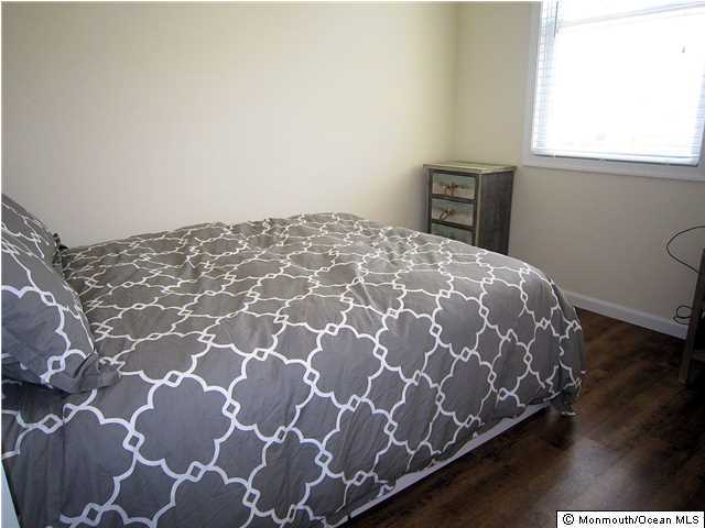 3305 Seaview Road Lavallette, NJ 08735 - Photo 7 of 13 a bed sitting in a bedroom next to a window