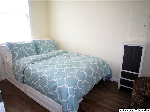 3305 Seaview Road Lavallette, NJ 08735 - Photo 8 of 13 a bed sitting in a bedroom next to a window