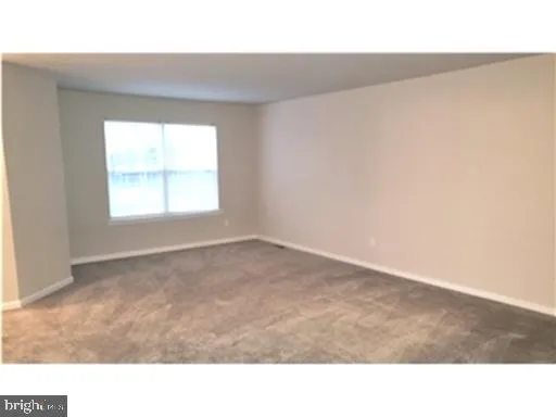 a room with high traffic carpet with window