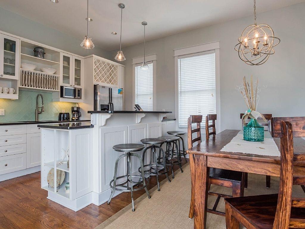 88 Chelsea Loop Road Santa Rosa Beach, FL 32459 - Photo 6 of 21 a kitchen with kitchen island granite countertop a table chairs a sink dishwasher a dining table and chairs in it