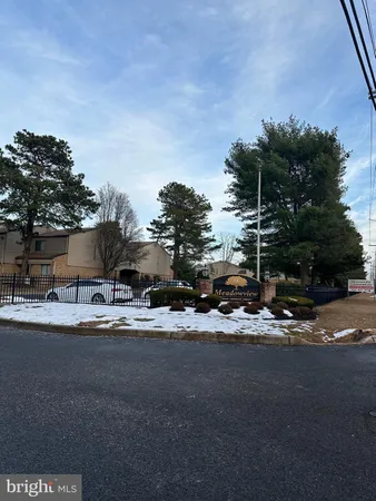 a view of a house with a street and a yard