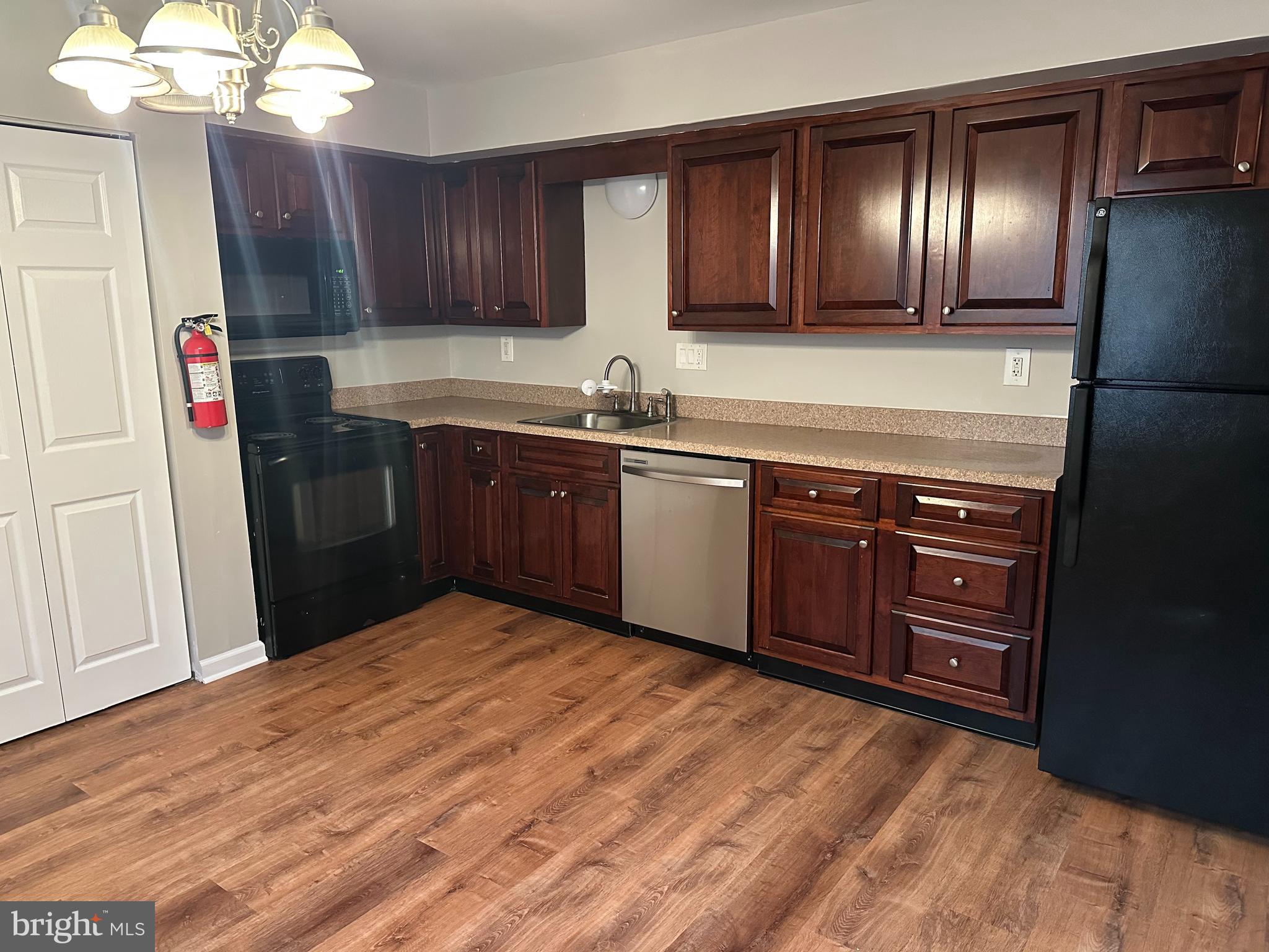 1801 Egg Harbor Road, Unit 105 Clementon, NJ 08021 - Photo 5 of 14 a kitchen with stainless steel appliances granite countertop a refrigerator and a sink