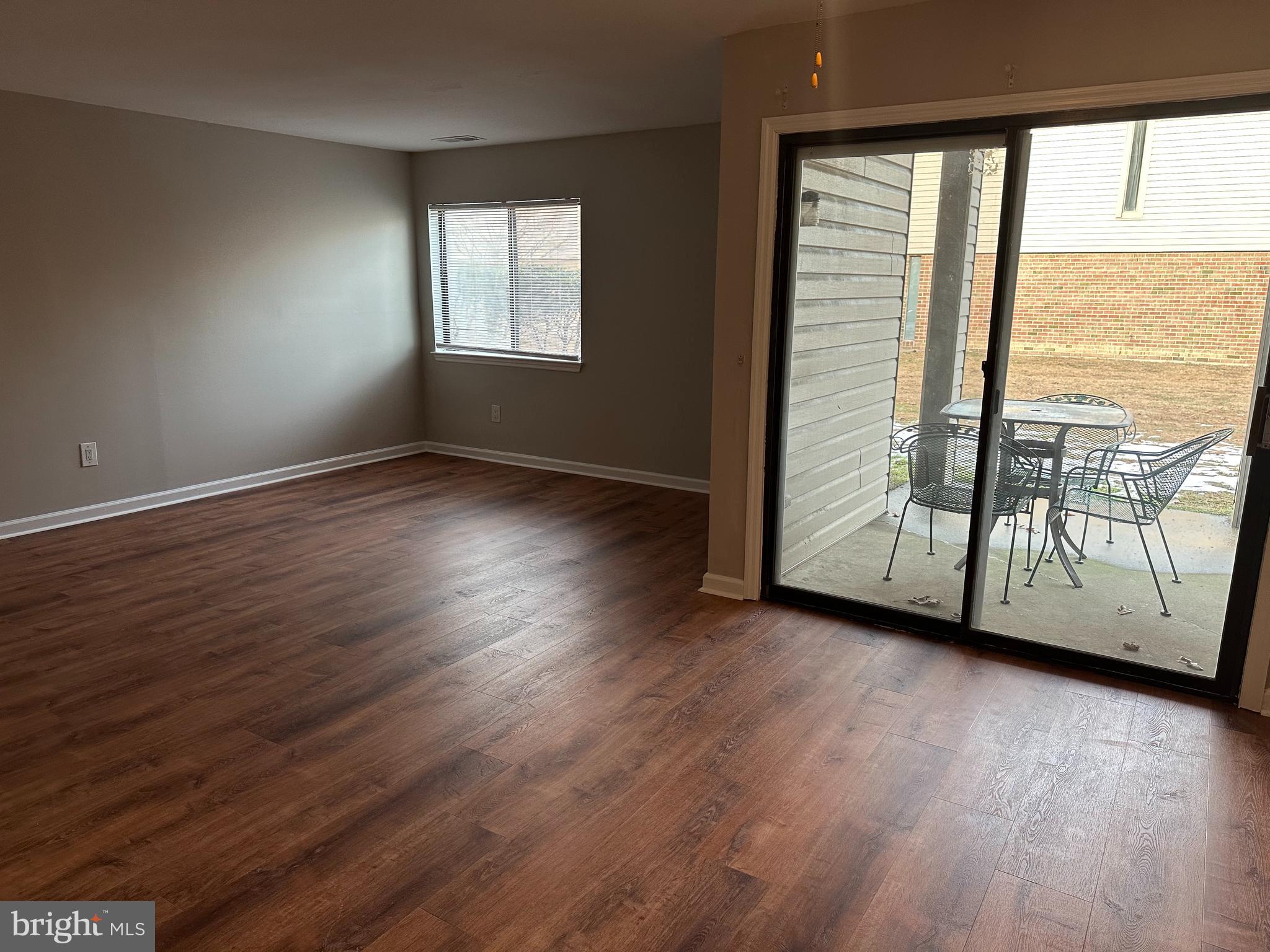 1801 Egg Harbor Road, Unit 105 Clementon, NJ 08021 - Photo 6 of 14 an empty room with wooden floor and windows