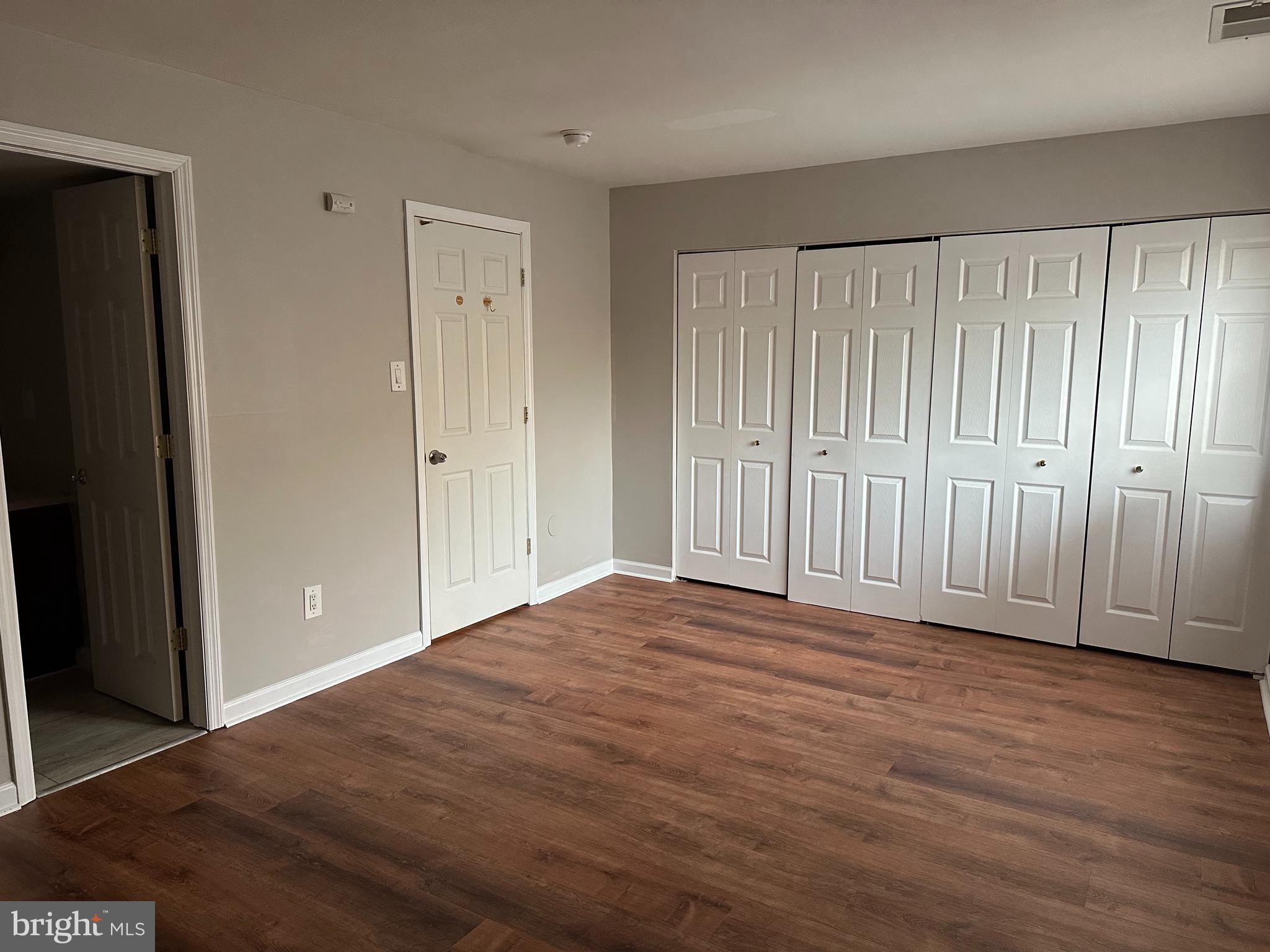 1801 Egg Harbor Road, Unit 105 Clementon, NJ 08021 - Photo 7 of 14 a view of an empty room with wooden floor