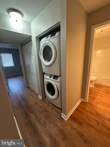 a utility room with wooden floor sink and cabinets
