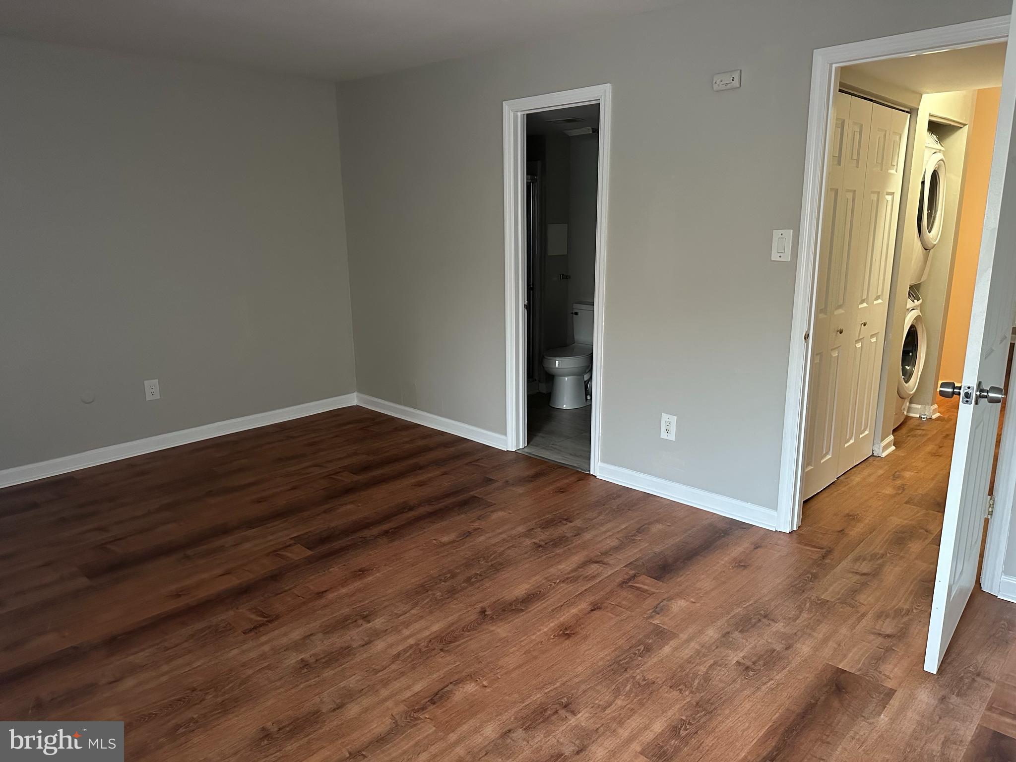 1801 Egg Harbor Road, Unit 105 Clementon, NJ 08021 - Photo 10 of 14 a view of an empty room with wooden floor and a window