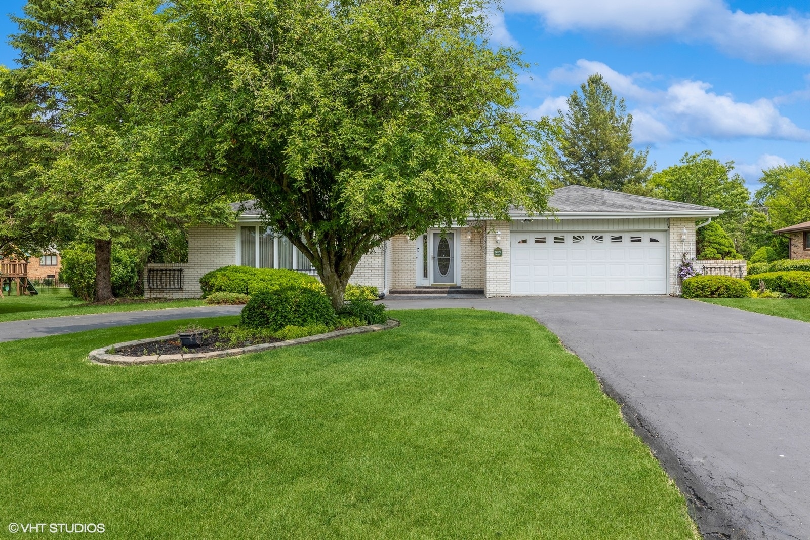 24827 Chestnut Lane Crete, IL 60417 - Photo 5 of 49 a front view of a house with a garden and trees