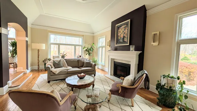 a living room with furniture fireplace and window