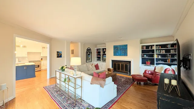 a living room with furniture fireplace and flat screen tv
