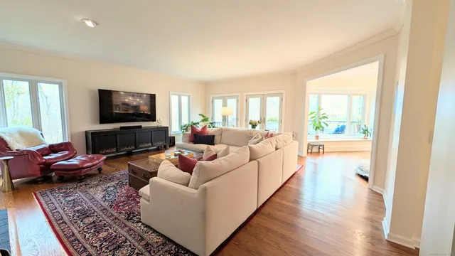 a living room with furniture wooden floor and a flat screen tv