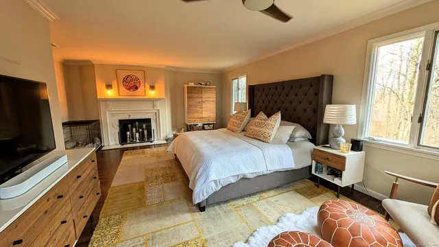 a spacious bedroom with a bed and a television