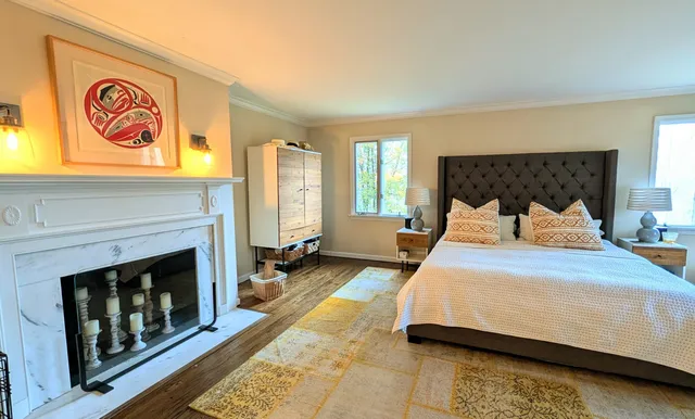 a bedroom with a bed and a fireplace