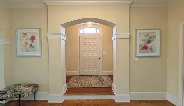 a view of livingroom with painting on the wall and a window