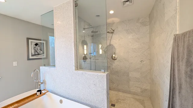 a bathroom with a bathtub and shower