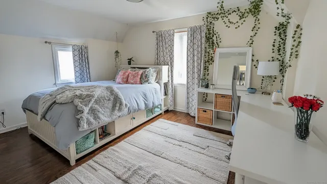 a bedroom with bed and wooden floor